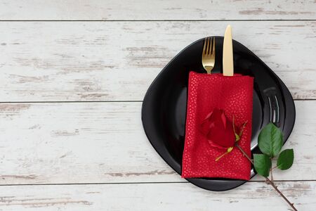 Festive table setting for Valentine's Day with golden fork and knife and holiday decorations. Copy space.の写真素材