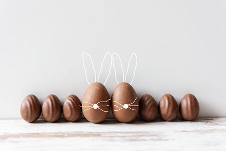 Delicious chocolate Easter eggs on wooden background. Easter concept. Copy space.の写真素材