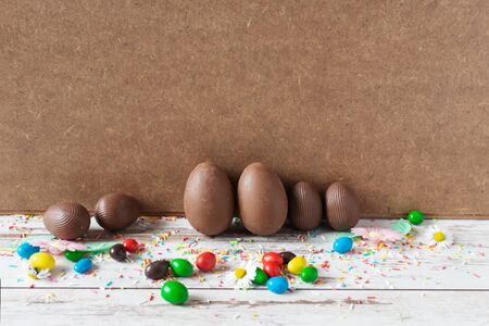 Delicious chocolate Easter eggs on wooden background. Easter concept. Copy space.の写真素材