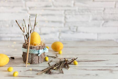 Yellow colored Easter eggs on wooden table. Happy Easter time. Creative Easter decoration. Copy space.の写真素材