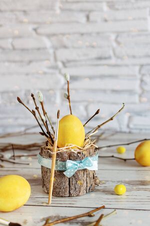 Yellow colored Easter eggs on wooden table. Happy Easter time. Creative Easter decoration.の写真素材