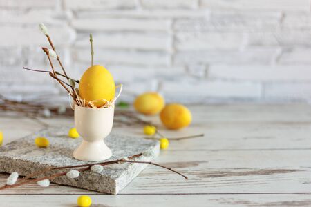 Yellow colored Easter eggs on wooden table. Happy Easter time. Creative Easter decoration. Copy space.の写真素材