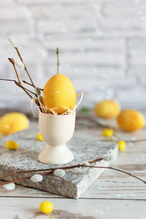Yellow colored Easter eggs on wooden table. Happy Easter time. Creative Easter decoration.の写真素材