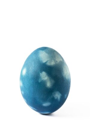 Marble blue easter egg isolated on white background. Easter egg painted in a modern classic blue color with marble effect. Happy easter time.の写真素材