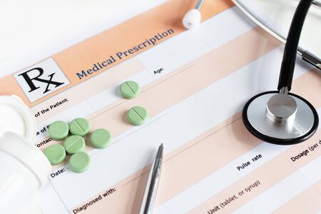 Medical prescription with doctor's sthetoscope and pills closeup.の写真素材