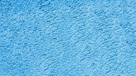 Texture of light blue cement concrete wall. Background of blue stucco wall.の写真素材