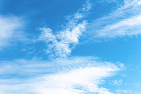 Blue sky background with white clouds in a sunny day. Texture of sky. Cloudscape.の写真素材