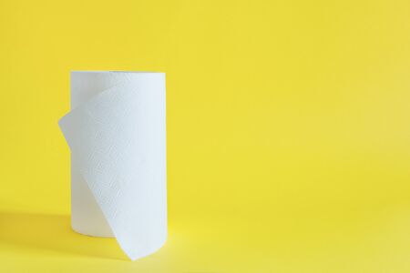 Roll of paper towel on yellow background. Disposable household towels.の写真素材