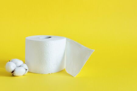 Rolls of toilet paper on yellow color background. Soft cotton toilet paper.の写真素材