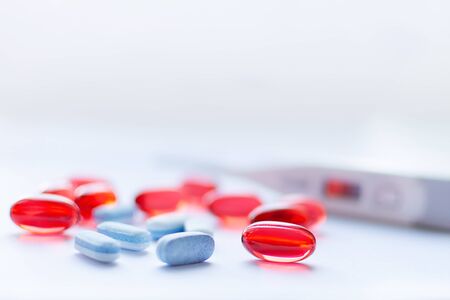 Red and blue capsules on white background. Pharmacy concept. Traditional medicine treatment.の写真素材