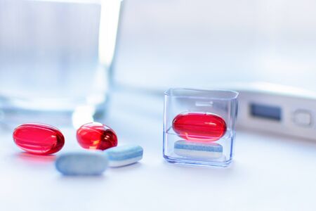Red and blue capsules on white background. Pharmacy concept. Traditional medicine treatment.の写真素材