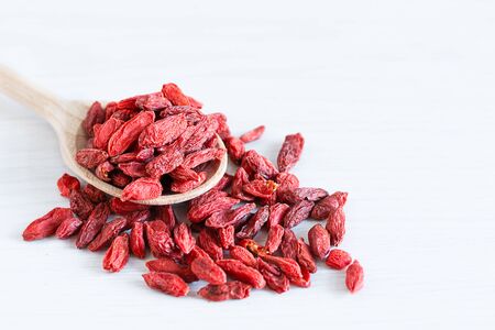 Wooden spoon of dried goji berries on white background. Superfoods. Healthy eating concept.の写真素材