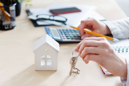 Real estate agent calculating taxes and profits to invest in home buying. Real estate market concept. Rental housing.の写真素材