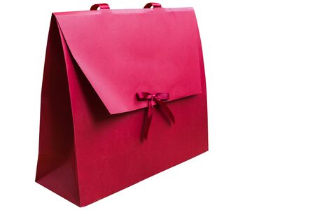 Cute gift paper bag isolated on white background. Mockup for design. Holiday gift red container.の写真素材
