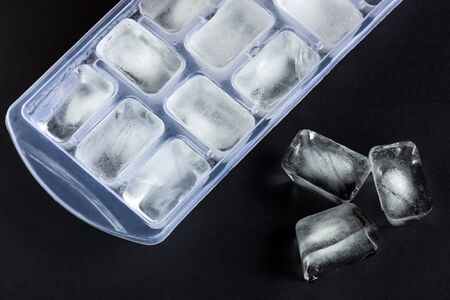 Ice cubes on the black background. Drinks refreshment. Crystal ice.の写真素材