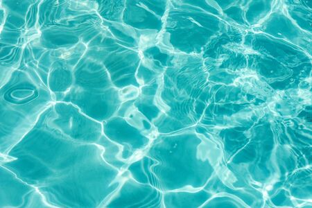 Background of clear turquoise water. Brigh blue reflection of water.の写真素材