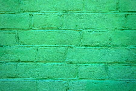 Texture of brick painted green wall. Stone old architecture background.の写真素材