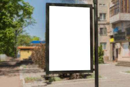 Blank advertisement board on the street of the city. Mockup for design. Empty ad banner outdoor.の写真素材