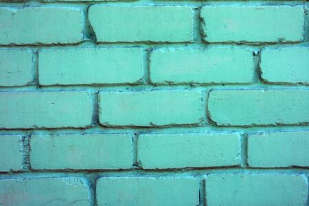 Texture of brick painted green wall. Stone old architecture background.の写真素材