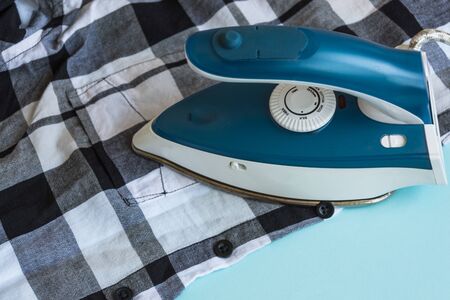 The ironing clothers process. A housework concept.の写真素材