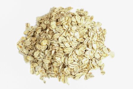 Heap of oat flakes isolated on white background. Healthy eating food. Dieting.の写真素材