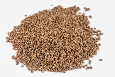 Heap of buckwheat isolated on white background. Organic cereals. Ingredient for porridge cooking.の写真素材
