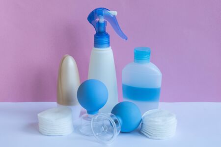 Plastic bottles and massage jars on pastel modern interior. Hygiene cosmetic concept.の写真素材