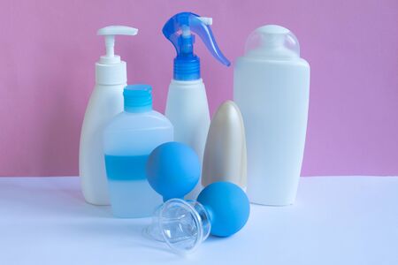 Plastic bottles and massage jars on pastel modern interior. Hygiene cosmetic concept.の写真素材