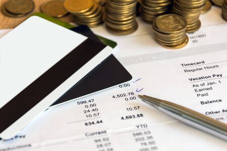 Paycheck, credit cards, coins top view. Finance accounting.の写真素材