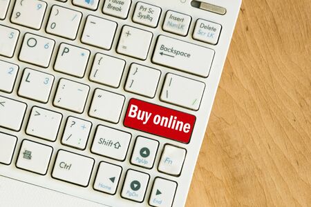 Laptop keyboard top view on wooden table background. Online shopping concept. Copy space.の写真素材