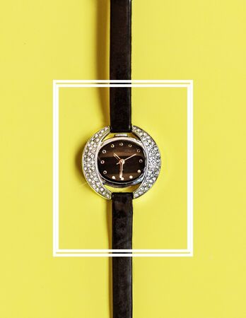 Elegance woman watch in white square on the pastel color background. Attractive luxury watch with diamonds.の写真素材