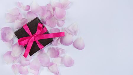 Gift box wrapped with ribbon on light background. Greeting card. Copy space.Mockup for design.
