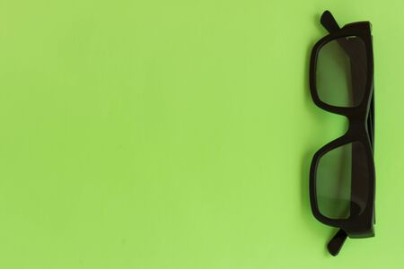 Spectacles on pastel color background. Top view. Mockup for design. Healthy vision, trendy accessory, 3d cinema.の写真素材