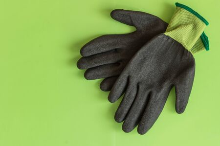Rubber gloves for garden working on pastel color background top view. Copy space. Mockup for design.の写真素材