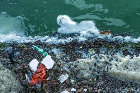 Plastic pollution of the river. Green water of the river. Ecological catastrophe.の写真素材
