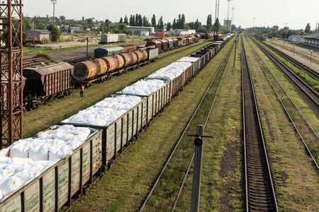 Cargo train in a railway station full of cargo.