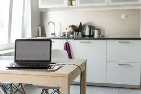 Kitchen modern interior. White kitchen furniture. Working at home- freelance concept.の写真素材