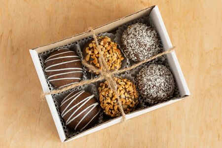 Different muffins in a gift box top view. Sweet chocolate cakes. Copy space.の写真素材