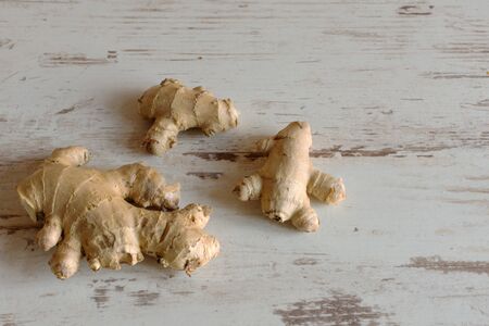 Ginger root on wooden background.の写真素材