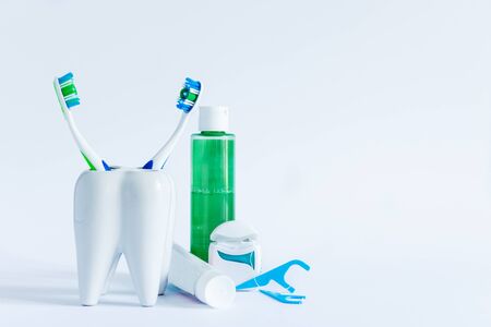 Oral hygiene products and model of tooth on white background. Dental care concept.の写真素材