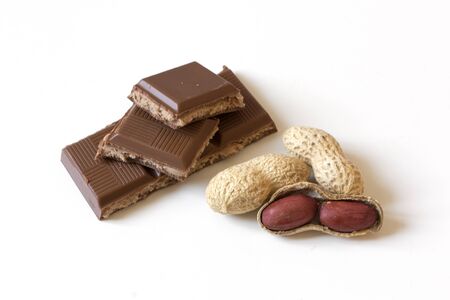 Dried peanut pile and chocolate stuffed with peanut butter isolated on white background. Healthy...