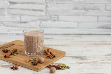 Masala chai made by brewing black tea with aromatic spices and herbs, such as Cinnamon Stick, Thai Cardamom, Ginger, Star Anise, Black Peppercorns, Nutmeg and Black Tea. Traditional indian masala tea.の写真素材