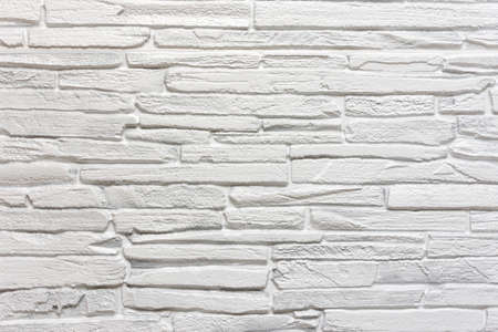 White stone wall background or texture. Construction industry. Home wall interior.