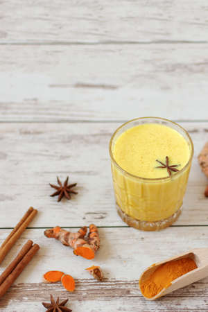 Golden turmeric milk with cinnamon and other aromatic spices. Healthy and aromatic detox beverage. Herbal medicine, anti-inflammatory therapy. Indian culture.の写真素材