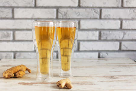 Fresh Ginger Ale with lime and ice or Kombucha in Bottle - Homemade lemon and ginger organic probiotic drink, copy space.の写真素材