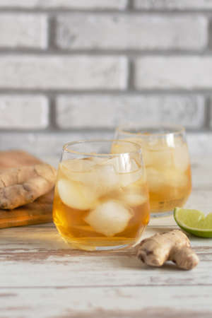 Fresh Ginger Ale with lime and ice or Kombucha in Bottle - Homemade lemon and ginger organic probiotic drink, copy space.の写真素材