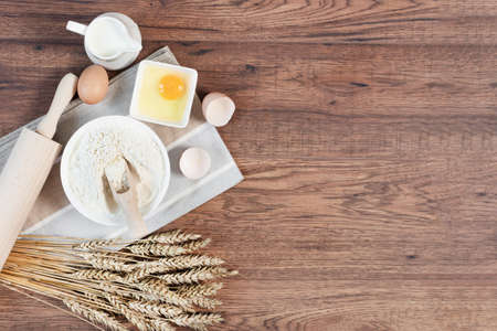Ingredients and tools for dough preparation on wooden background top view. Baking background.の写真素材