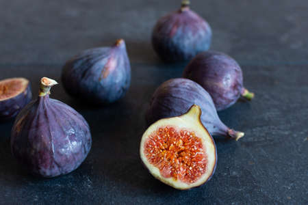 Fresh ripe figs on black background. Healthy tropical fig fruit.の写真素材