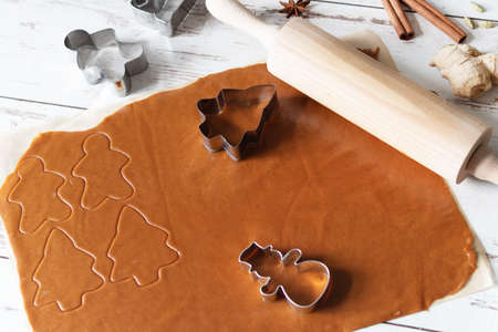 Preparing homemade gingerbread cookies for the Christmas holiday. Spicy dough and cutters in...