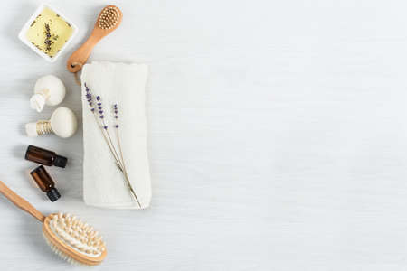 Organic spa products for massage and skin care with lavender oil and herbal balls top view on white wooden background. Spa treatment background.の写真素材